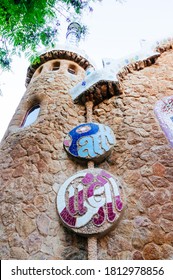 Barcelona, Spain - 06.21.2015: Fence With Ginger Bread Texture And Mosaic Medallion On The Outside Of Guell Park In Barcelona Spain