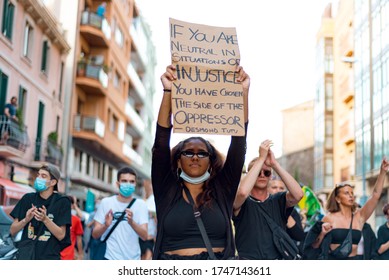 Barcelona, Spain - 1 June 2020: Black Confident And Determined Woman March In Demanding End Of Police Brutality And Racism With Black Lives Matter Movement For End Of Injustice