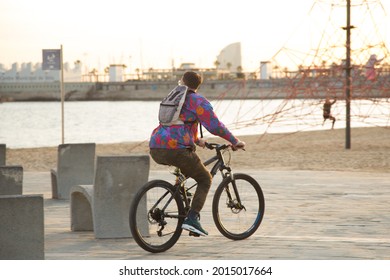 Barcelona, Spain, 1st April 2021. Lifestyle Shoot In El Poblenou. People Cycling Next To The Beach.