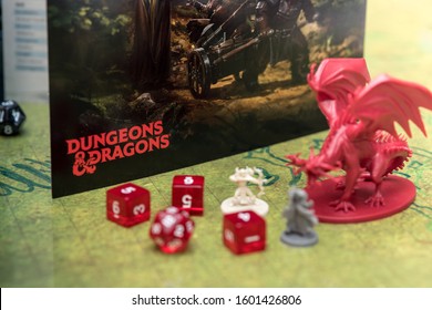Barcelona, Spain, 22 December 2019: Playing Dungeons and Dragons role play board game. Dices and miniatures on the battlefield. Focus on the logo of the role play game.