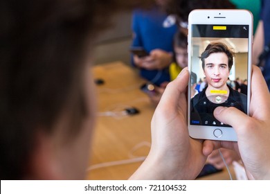 BARCELONA, SPAIN - 23 SEPTEMBER 2017: Man making selfie and using new portrait mode on the iPhone 8 - iPhone 8 Plus Silver hands-on in Apple Store. Selective focus and shallow DOF, close up view.