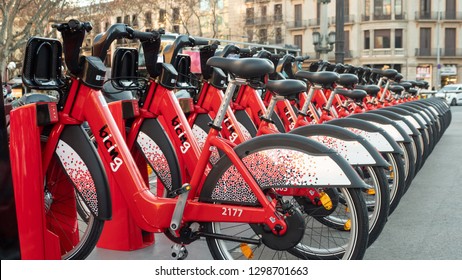 BARCELONA, SPAIN - 25 JANUARY 2019: Row of red bicycles in a bike rack, available for rental on the streets of Barcelona