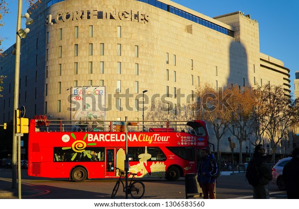 Barcelona, Spain - 28\
January 2019: Tourists rides double decker bus. Barcelona City Tour\
is a new official touristic bus service that shows the city with an\
audio guide.