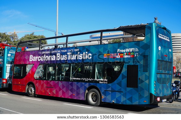 Barcelona, Spain - 28\
January 2019: Tourists rides double decker bus. Barcelona City Tour\
is a new official touristic bus service that shows the city with an\
audio guide.