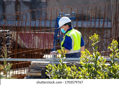 Mataró, BARCELONA, SPAIN; April 14 2020: Construction Workers Return To Work With Masks Protected Against Covid-19. Back To Work. Building Construction.