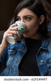 BARCELONA, SPAIN - APRIL 22, 2016: Beautiful Young Woman Drinking Coffee At Starbucks Cafe In Barcelona