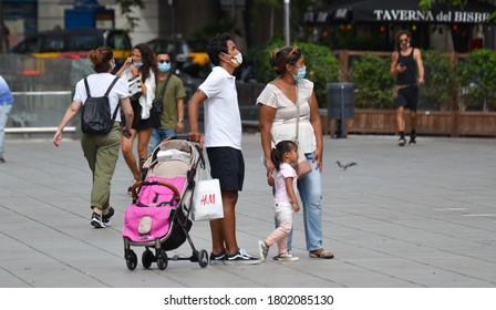 Barcelona, Spain, August 24, 2020: Latin American Family Wearing Protective Covid-19 Face Mask. Touristy Spots In The Covid Era