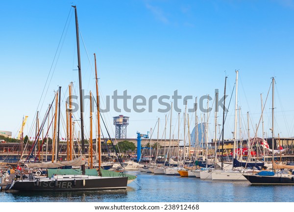 Barcelona,\
Spain - August 26, 2014: Vista port view with Montjuic cable car\
tower and sailing boats moored in\
Barcelona