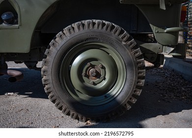 Barcelona, Spain; August 5, 2022: Detail Of An Old Green Jeep Willys Military SUV. Front Wheel