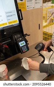 Barcelona, Spain, December 21, 2021: Young Woman Preparing To Pay At The Self-service Counter In IKEA Furniture Store Scanning Paying For Products