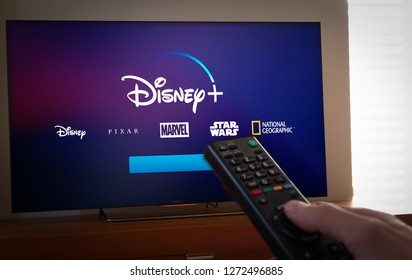 Barcelona, Spain. Jan 2019: Man Holds A Remote Control With The New Disney+ Screen On TV. Disney+ Is An Online Video Streaming Subscription Service.Illustrative