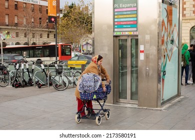 Barcelona, Spain, January 20, 2020: View Of An Older Woman With A Pram Near A Lift Down To The Plaza De Espana Subway Rail Station