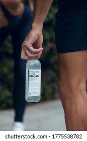 BARCELONA, SPAIN - JULY 2020: Group Of Runners Sitting With Bottle In Hand. In The City Of Barcelona.