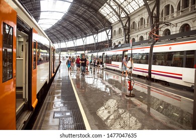 BARCELONA, SPAIN - JULY 26, 2019: Passengers Walking Along Wet Platform After Rain At Barcelona Estació De França Railway Station.