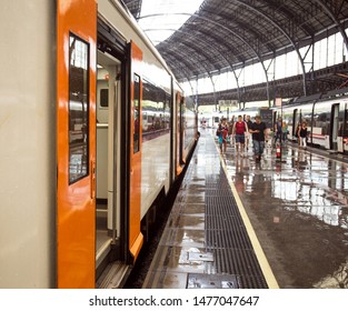 BARCELONA, SPAIN - JULY 26, 2019: Passengers Walking Along Wet Platform After Rain At Estació De França Railway Station.