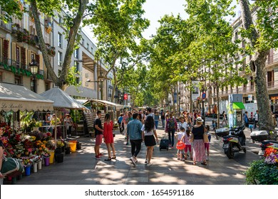 BARCELONA, SPAIN - JUNE 03, 2019: Crowd Of People And Central Downtown Barcelona City On La Rambla Street