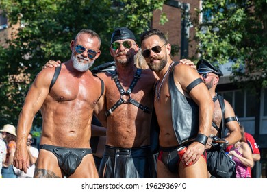 Barcelona - Spain. June 29, 2019: Trio of mature gay men in sex club suits consisting of leather vest, leather skirt, jockstraps, harnesses, caps