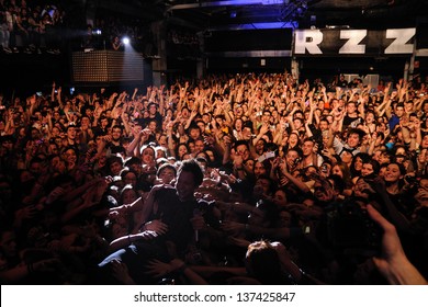 BARCELONA, SPAIN - MARCH 13: Pierre Bouvier, singer of Simple Plan band, surrounded by his fans, performs at Razzmatazz on March 13, 2012 in Barcelona, Spain.