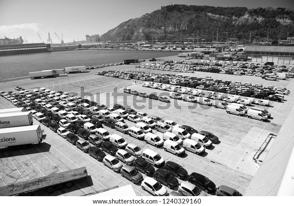 Barcelona,\
Spain - March 30, 2016: new cars on parking in sea port. Auto\
export and car import. Vehicles shipment. Car trade commerce.\
Shipping activity. Car exhibition for\
sale.