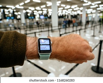 BARCELONA, SPAIN MAY 11, 2018: Crop male hand with Apple Watch Series 3 smartwatch using device while standing in light modern airport Wallet App with Eurowings ticket 