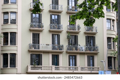 Barcelona, Spain - May 19, 2024: View of a typical Barcelona building architecture in Barcelona, Spain. Apartment building balcony windows with wooden shutters. - Powered by Shutterstock