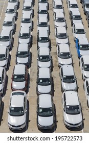 Barcelona, Spain - May 23, 2014: New cars parked in a row in the port of Barcelona. They are waiting to be shipped. 