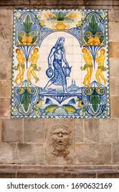 Barcelona, Spain, May 29, 2017: View Of Tile Mosaic Of Woman Carrying Water Jugs, Embedded Into The Wall Of An Old Stone Building In The Centre Of Barcelona