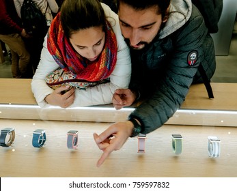 BARCELONA, SPAIN - NOV 13, 2017: Young spanish couple selecting the latest Apple Watch Series 3 wirst in the Apple Store
