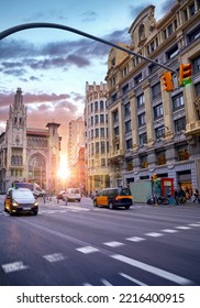 Barcelona, Spain. Wide Street Avenue With Yellow Cars Taxi And High Buildings. Traffic Jam In Centre Of Grand City. Cityscape Sunny Day.