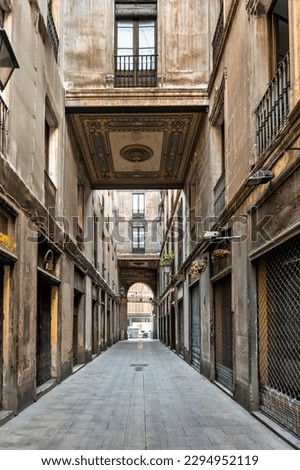 Barcelona, Spain-April 24, 2023. Exploring Barcelona's Gothic Quarter, a narrow alley of beautiful architecture winds its way through the Pasaje de la Paz, creating an arch 