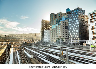 Barcode district landscape of Oslo in Norway with railway station and buildings at sunset in winter