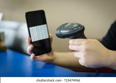 A Barcode Scanner Scanning A Barcode On A Mobile/cellular Phone Screen. Business And Technology Concepts.