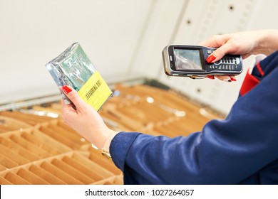 barcode scanner usage. Female worker scanning the item