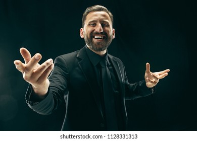 The Barded Man In A Suit. Stylish Business Man On Black Studio Background. Beautiful Male Portrait. Young Emotional Man. The Human Emotions, Facial Expression Concept. Italian Look.