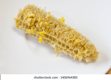 Bare Corn Cob Of A Boiled Sweet Yellow Corn After Eating In A White Saucer Plate. Close Up Shot. 