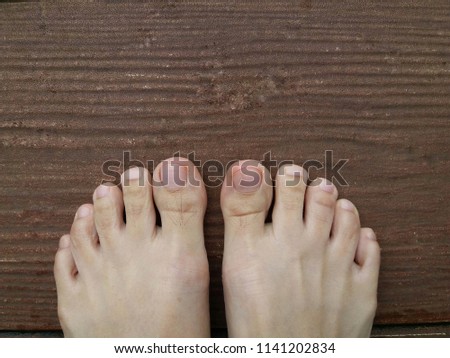 bare feet, asian woman feet on brown wooden floor