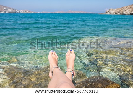 Bare feet  at the beach on the Cyclades Island, Greek 