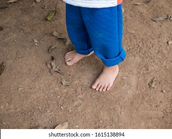 Bare Feet Of Child On Ground. Kid Playing No Shoes Outdoors In Rural Countryside. Fun And Freedom Concept.