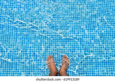 Bare Feet Cooling Off In The Pool Relaxing Concept