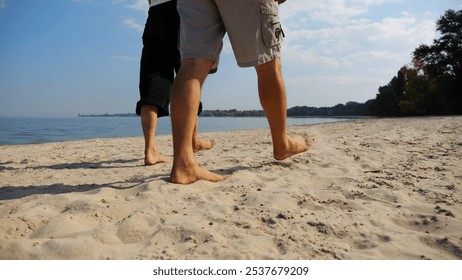 Bare feet of couple stepping together along beach at ocean background. Male and female legs of pair walking near sea. Happy lovers going on sandy shore. Concept of summer vacation or holiday. - Powered by Shutterstock