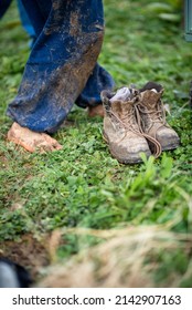 Bare Feet And Dirty Shoes. Bad Weather, Mud. Hike, Rest Legs Concept.