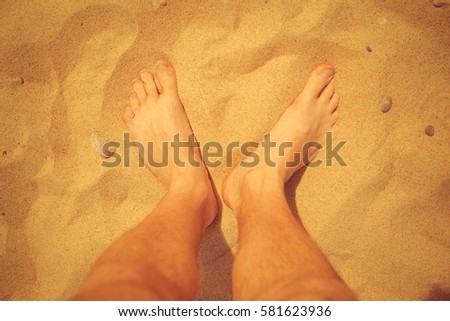 bare feet in the hot sand