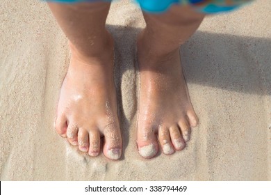 Bare Feet Little Kid Stand On Beach, Top View
