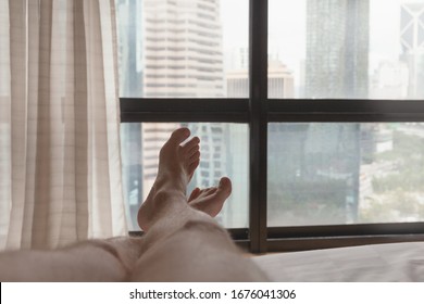 Bare Feet Of A Man Lying In A Bed, First Person View