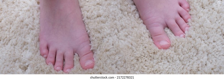 Bare Feet Of A Man On A Warm Fluffy Beige Carpet