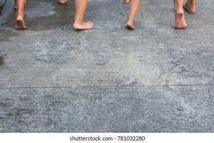 The Bare Feet Of Many Boys Were Running Forward On The Concrete Floor.