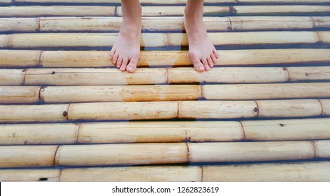 Bare Feet On Bamboo Raft.