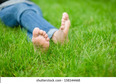 bare feet on green grass, copy space