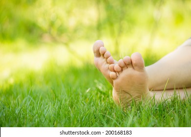 bare feet on green grass, copy space 