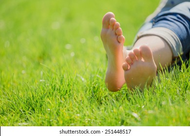 bare feet on green grass, copy space